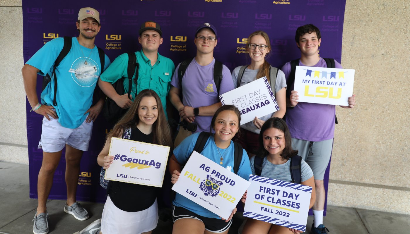 Students hold first day signs