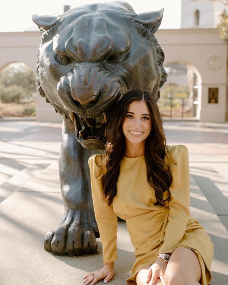 Calyx Verret in front of tiger statue