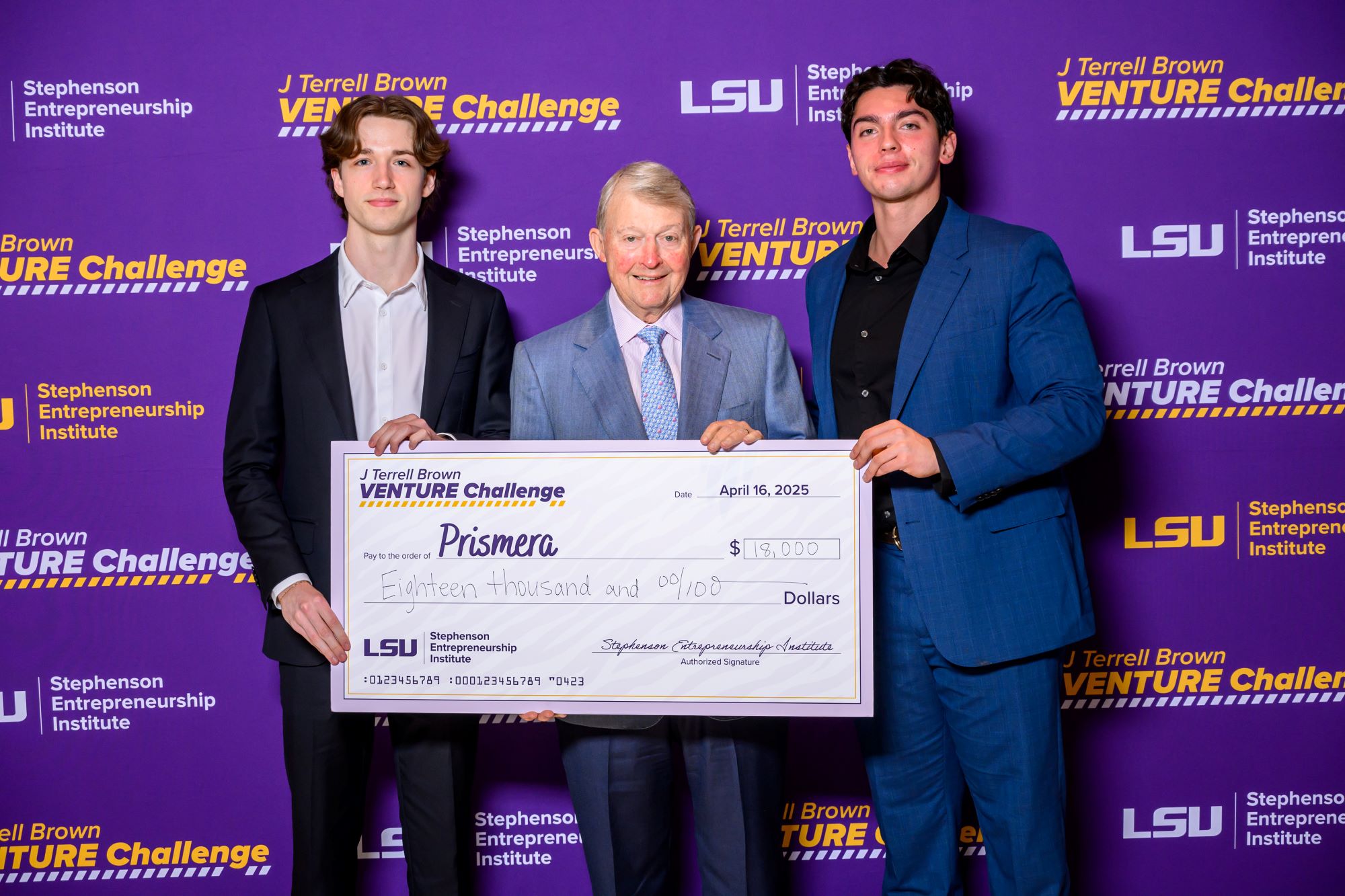 Three men holding a large check