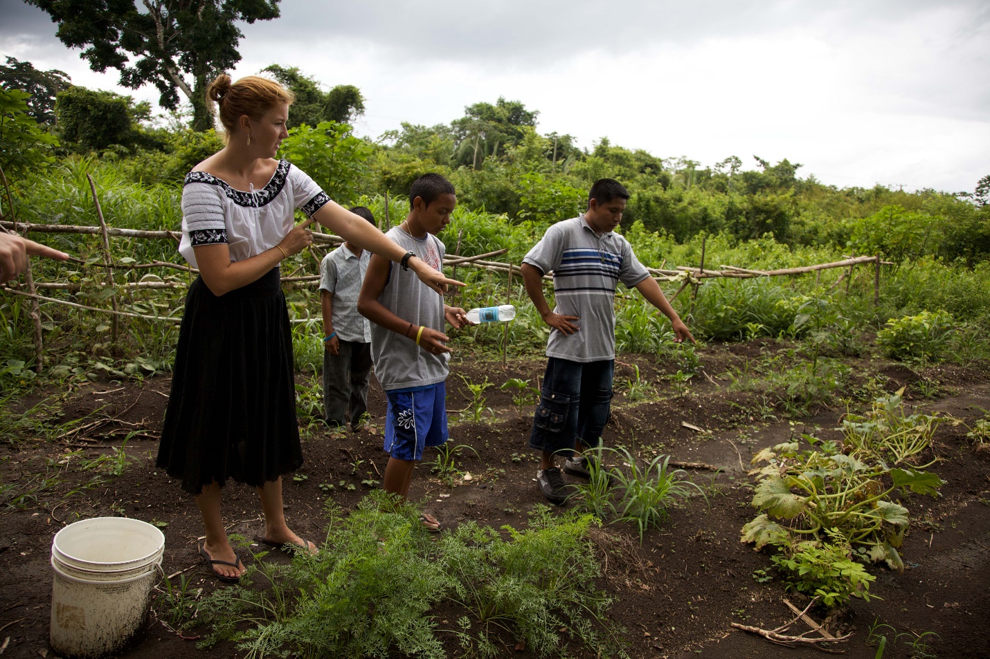 Volunteer working with community to plan a farm.