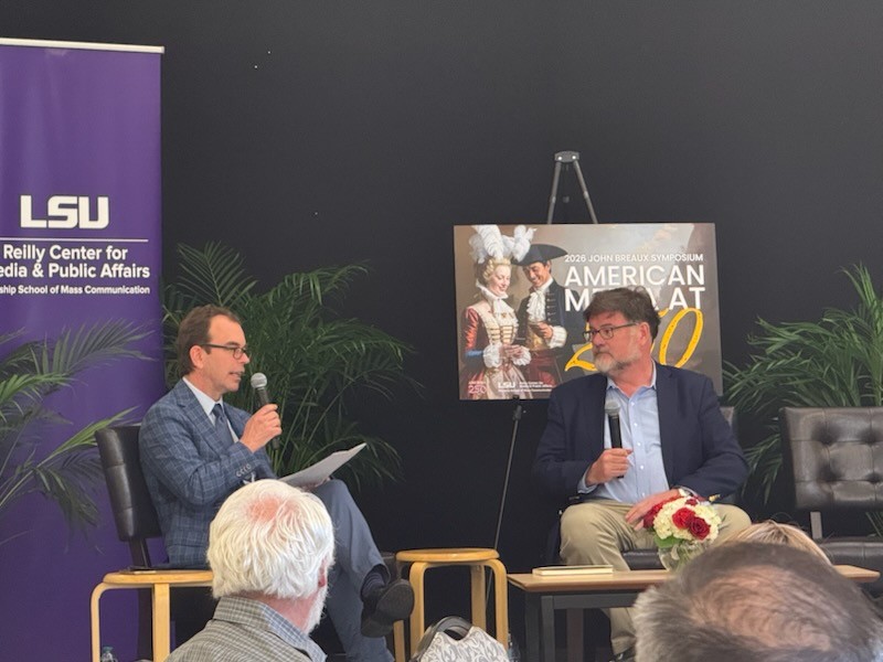 Two speakers at the 2026 John Breaux Symposium speaking to an audience.