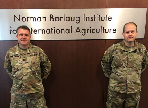 U.S. Army Maj. Gustavo Ferreira standing with U.S. Army Maj. Jamie Critelli