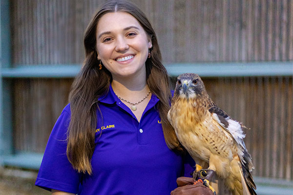 Mary Claire Stewart with red-tailed hawk